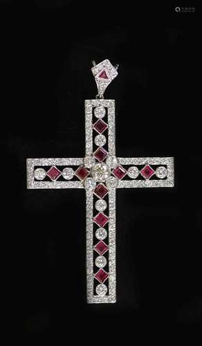 A modern pierced white gold, ruby and diamond cross pendant