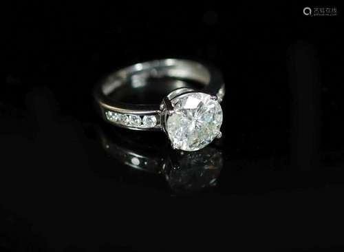 A modern white gold and single stone diamond ring, with eigh...