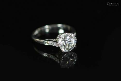 A platinum and single stone diamond ring, with diamond set s...