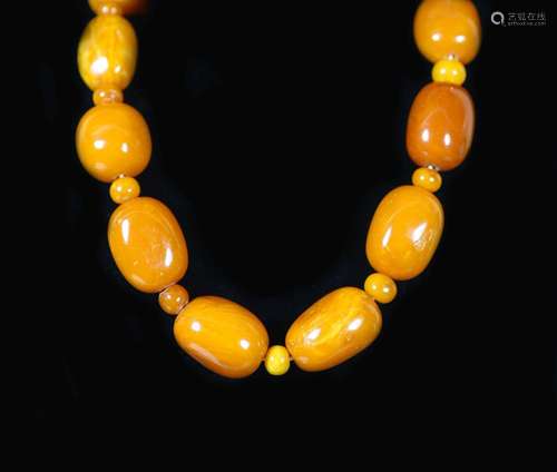 A single stand barrel shaped amber bead necklace, with amber...