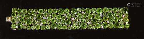 A Continental 18k gold and graduated round cut peridot encru...