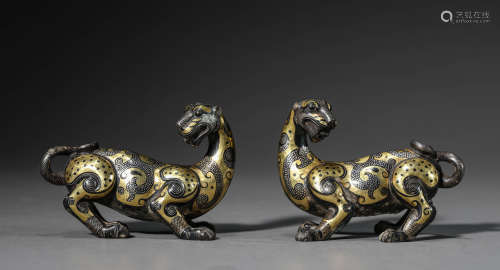 A Pair of Chinese Gold and Silver Inlaid Bronze Beasts