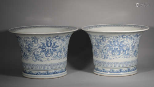 A pair of large flowerpots with light description of blue an...