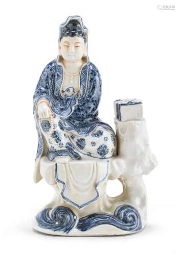 A CHINESE WHITE AND BLUE PORCELAIN SCULPTURE OF GUANYIN, FIR...