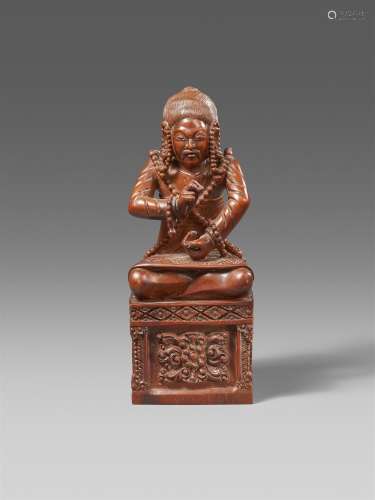 A rare Tibetan wooden figure of a dignitary in the style of ...
