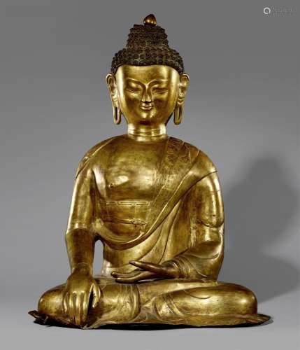 A large Tibetan gilt copper repoussé figure of Buddha Shakya...