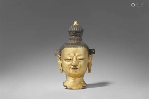 A Tibetan gilt copper repoussé head of a bodhisattva. 18th/1...