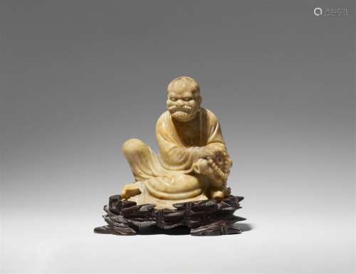 A soapstone figure of a seated luohan. 18th/19th century