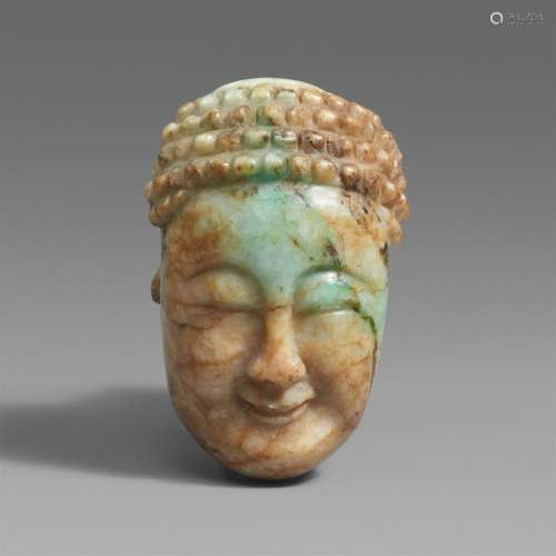 A mottle jade head of a smiling Buddha.