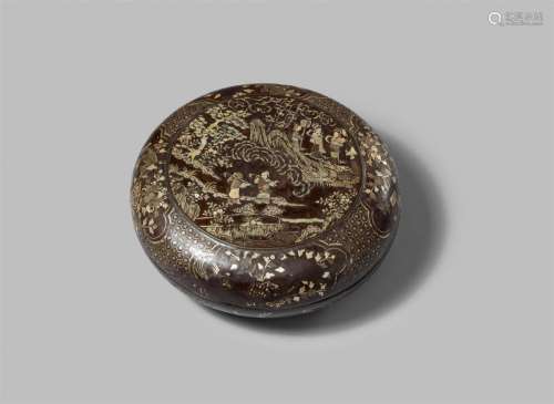 A black lacquer and mother-of-pearl inlaid round box and cov...