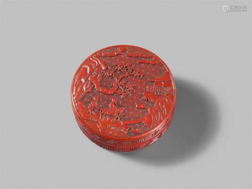 A small, round carved red lacquer box, probably for seal pas...