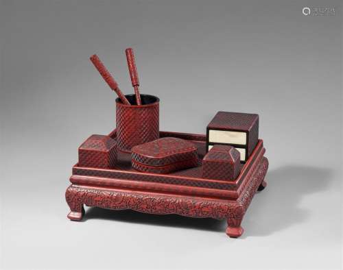 A set of writing objects on a table in the manner of carved ...