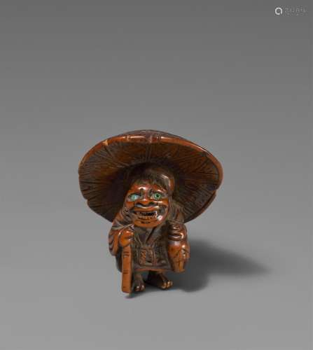 A boxwood netsuke of an oni with a tokkuri. 19th century