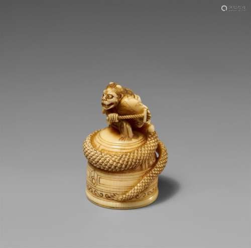 An ivory netsuke of Kiyohime on top of the Dojoji bell. 19th...