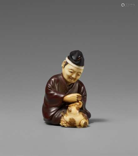 A wood and ivory netsuke of a courtier with a puppy. Late 19...