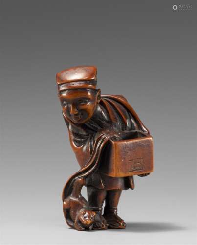 A wood netsuke of a street performer with a weasel. 19th cen...