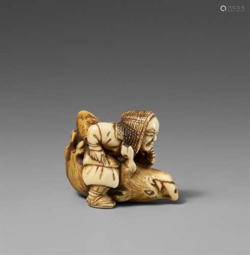 An ivory netsuke of a hunter with a boar. 19th century