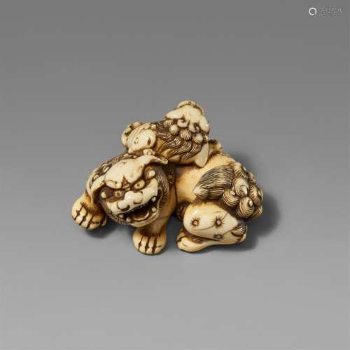 An ivory netsuke of a shishi and a cub. Late 18th century