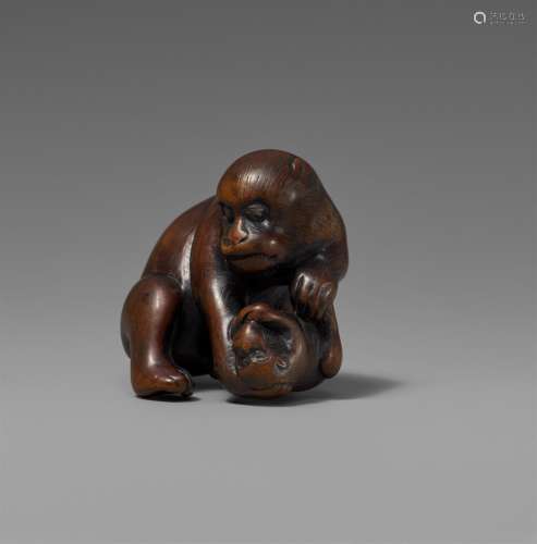A wood netsuke of a monkey and sibling. 19th century