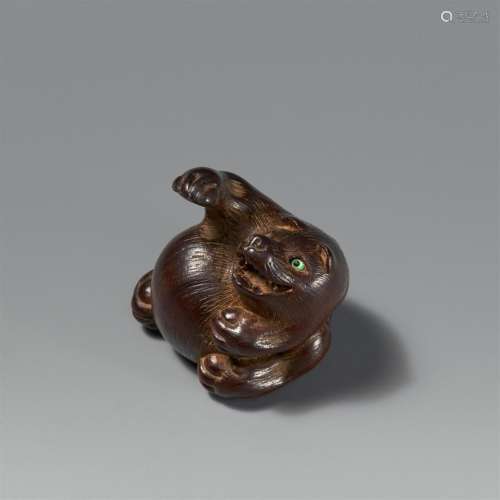 A wood netsuke of a tanuki. 19th century