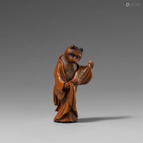 A boxwood netsuke of a cat in kimono. Late 19th century