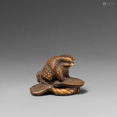 A boxwood netsuke of a toad on a sandal. Late 19th century