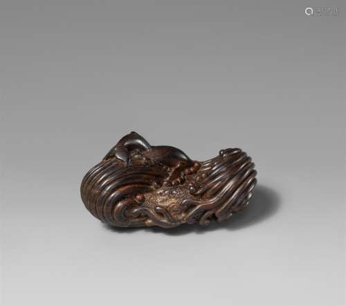 A wood netsuke entitled "Breaking wave", by Leigh ...