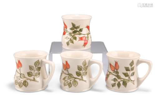 A SET OF FOUR MOORCROFT POTTERY MUGS, each tubelined and han...