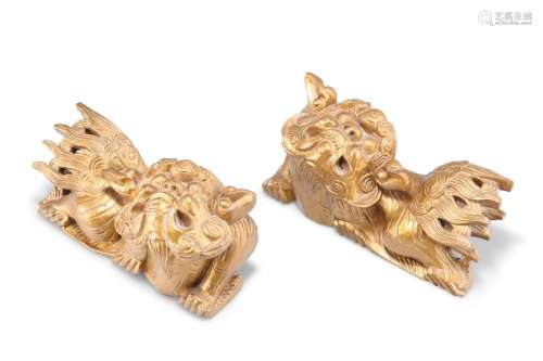 A PAIR OF 19TH CENTURY CHINESE GILTWOOD CARVINGS OF FU DOGS....