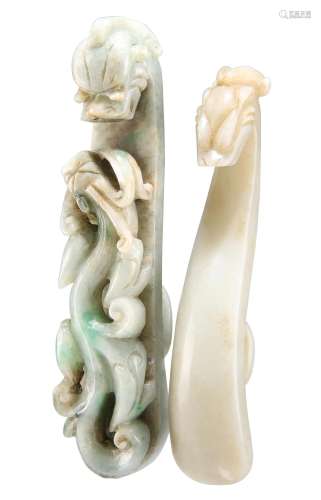 TWO CHINESE CARVED JADE BELT HOOKS, each with dragon head te...
