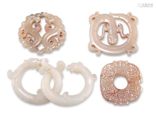 FOUR CHINESE CARVED JADE PENDANTS, including A PENDANT FORME...