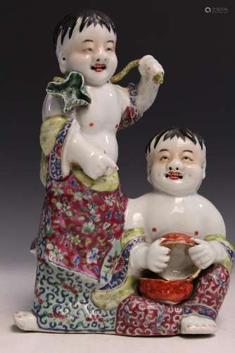 Chinese famille rose porcelain statue of two boys.