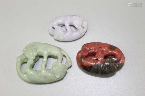 Three Chinese carved stone pendants.