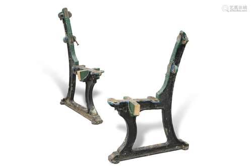 A PAIR OF CAST IRON BENCH SUPPORTS, each cast GNR, remnants ...