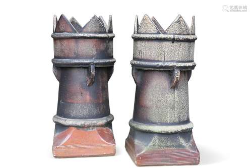 A PAIR OF SALT-GLAZED CHIMNEY POTS, each with crown-top. (2)...