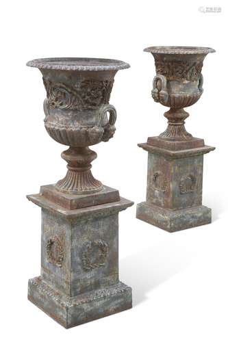 A FINE PAIR OF CAST IRON 'MEDICI' URNS ON STANDS, ...