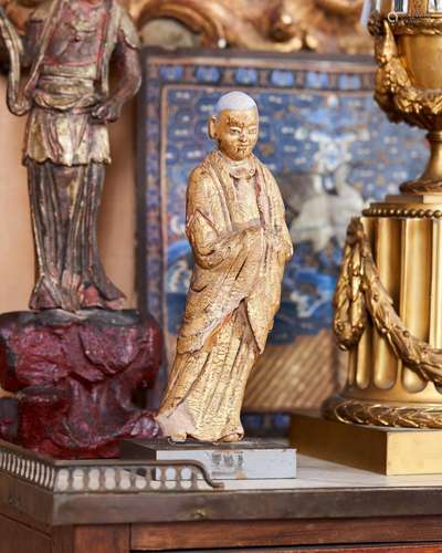 116 - A GILT AND POLYCHROME STUCCO FIGURE OF A MONK