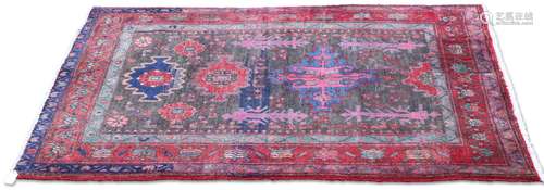 A PERSIAN LORI RUG, the grey field with repeat medallions an...