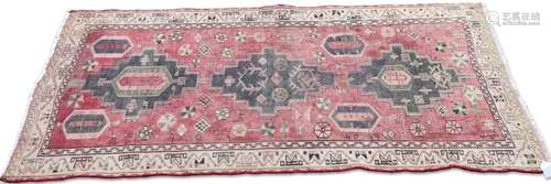 A PERSIAN HAMADAN RUG, the faded raspberry field with all-ov...