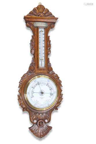 AN EDWARDIAN CARVED OAK ANEROID BAROMETER, signed 'Raus...