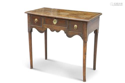 A GEORGE III OAK LOWBOY, the moulded rectangular top above t...