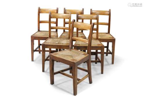 A SET OF SIX 19TH CENTURY COUNTRY BEECH AND RUSH SEATED DINI...