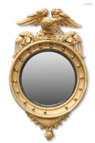 A 19TH CENTURY GILTWOOD CONVEX MIRROR, with eagle crest and ...