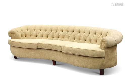 A VINTAGE AMERCIAN DEEP-BUTTONED SOFA, concave, raised on sh...