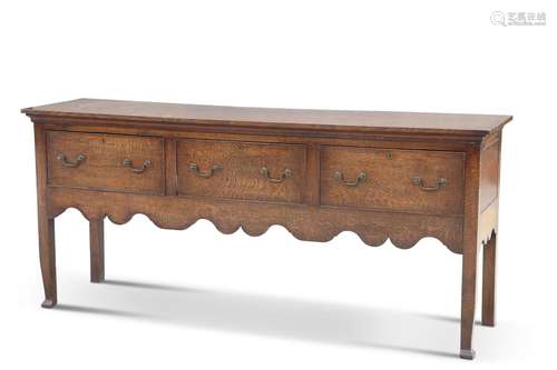 A GEORGE III OAK DRESSER, the rectangular top above three fr...