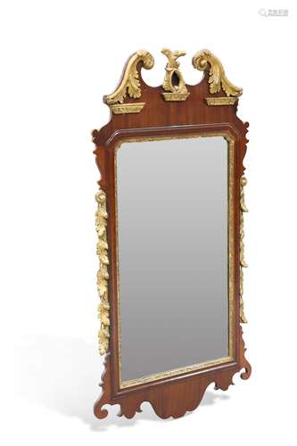 A 19TH CENTURY PARCEL-GILT MAHOGANY FRETWORK MIRROR, with sw...