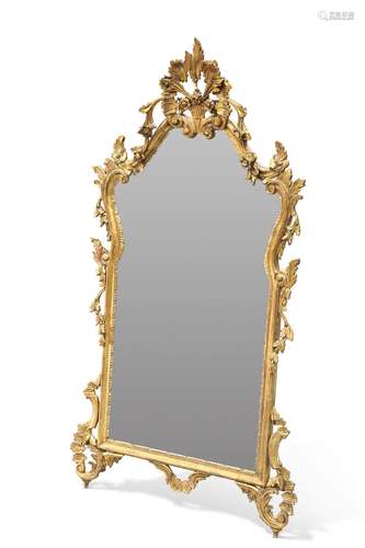 A ROCOCO-STYLE GILT-COMPOSITION MIRROR, the shaped rectangul...