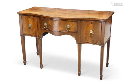 A GEORGE III-STYLE MAHOGANY SERPENTINE SIDEBOARD, fitted wit...