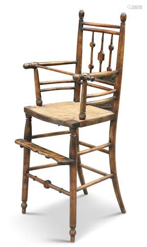 AN ARTS AND CRAFTS BEECH HIGH CHAIR, with rush seat and turn...