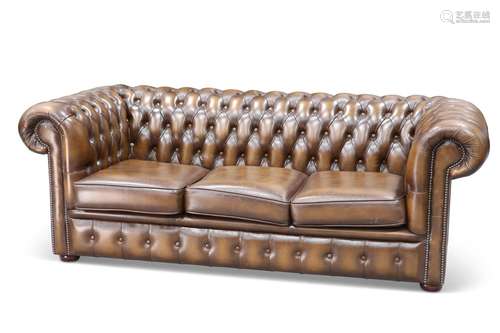 A CHESTERFIELD DEEP-BUTTONED BROWN LEATHER SOFA, with three ...